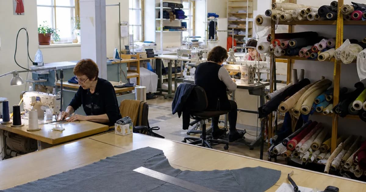 A small European garment atelier, with fabric rolls and sewing stations